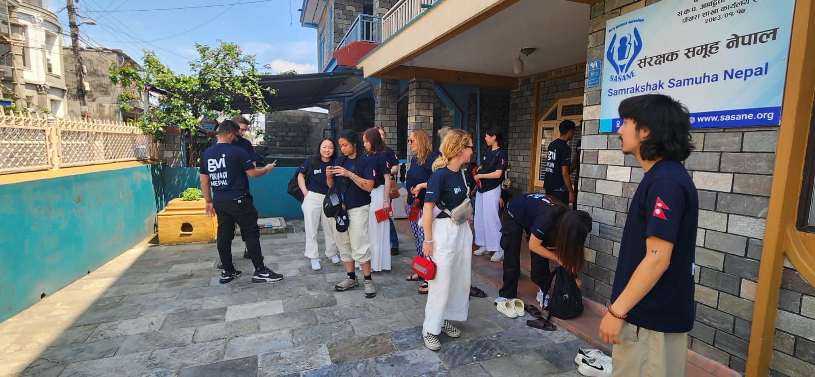 The student group outside the office of a survivor-led organization in Nepal