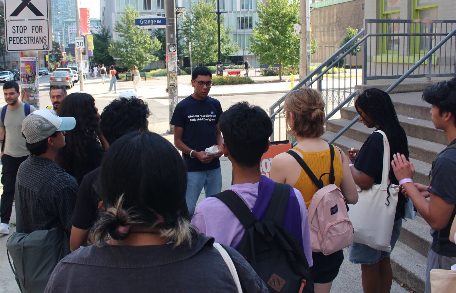 Jugraj speaking to a group of students on a downtown Toronto street corner during a SAID tour