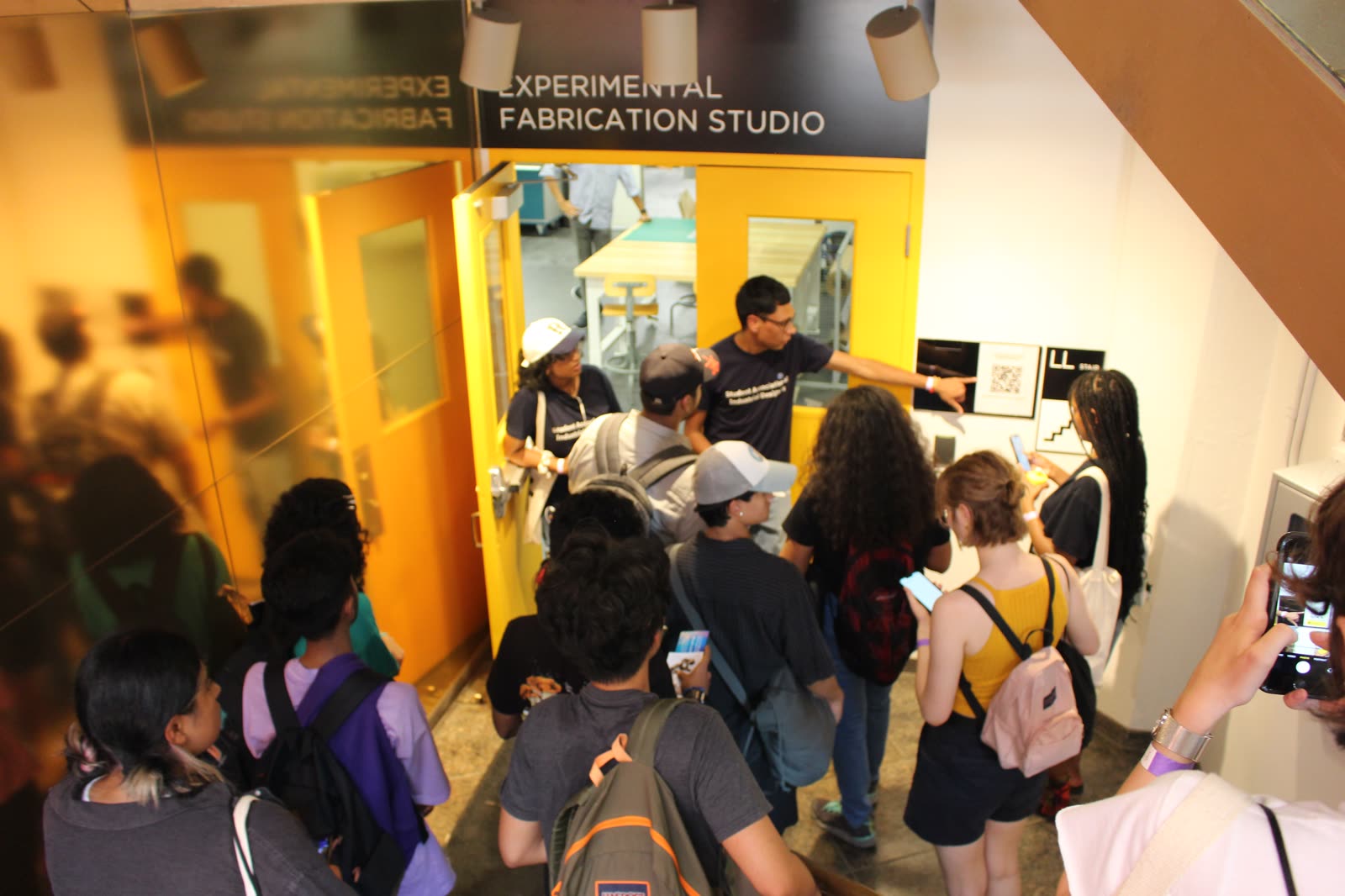 Jugraj leading students on a tour of an OCAD University fabrication studio