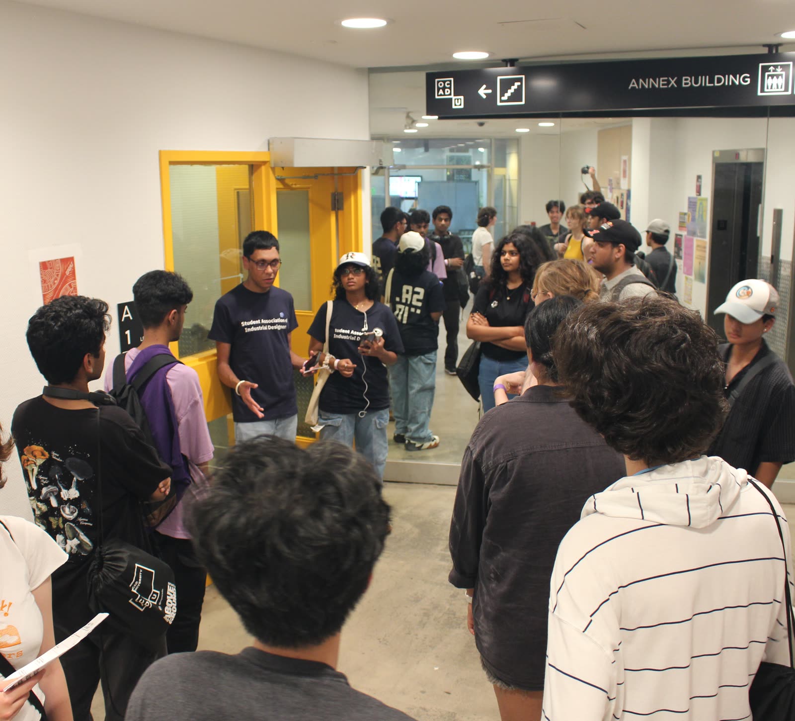 Jugraj addressing students inside an OCAD University building